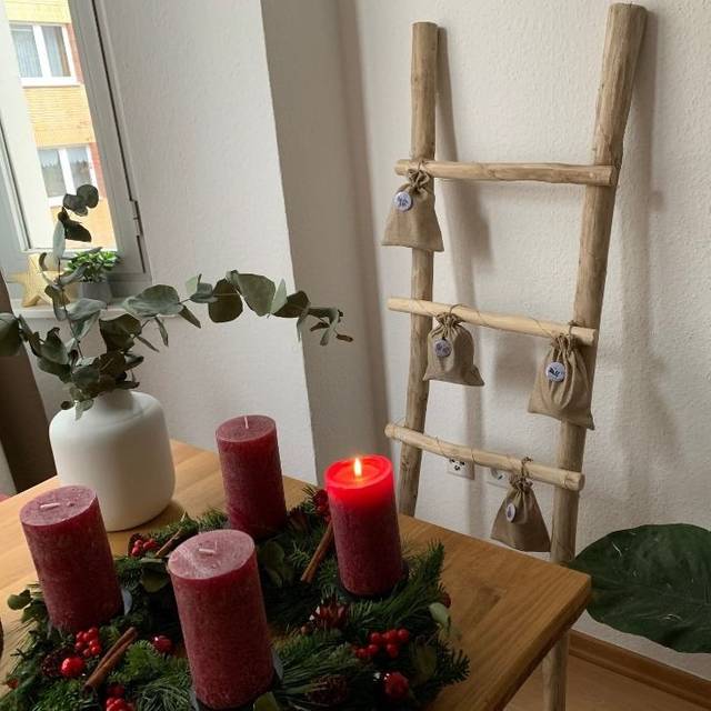 Selbstgemachter Adventskalender, im Vordergrund ein Adventskranz