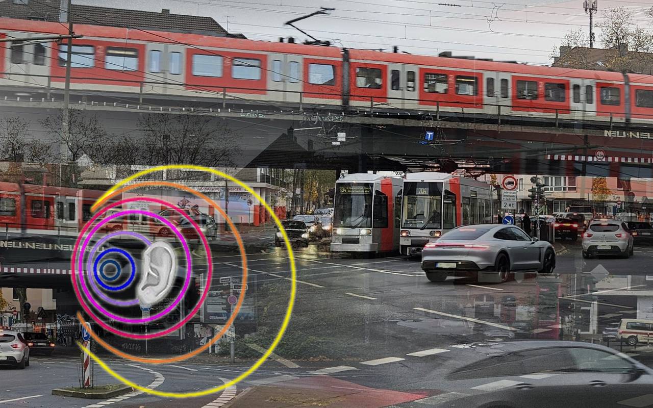 Eine Kreuzung mit Autos, Bahnen und einer S-Bahn. Krach