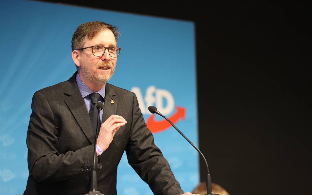 Marco Vogt von der AfD steht auf einer Bühne vor einem Mikrofon und hält eine Rede.