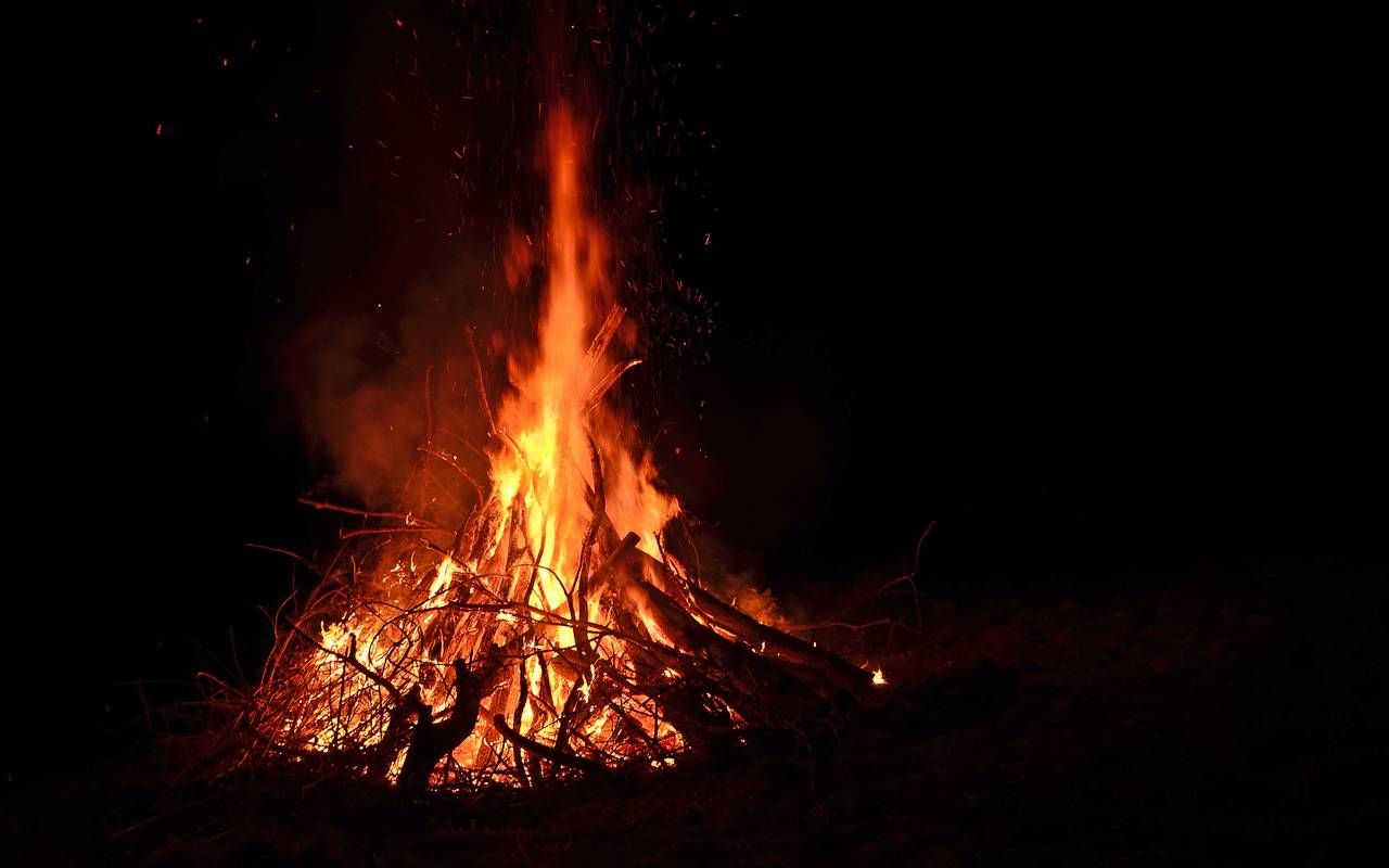 Ein brennendes Osterfeuer in der Dunkelheit.