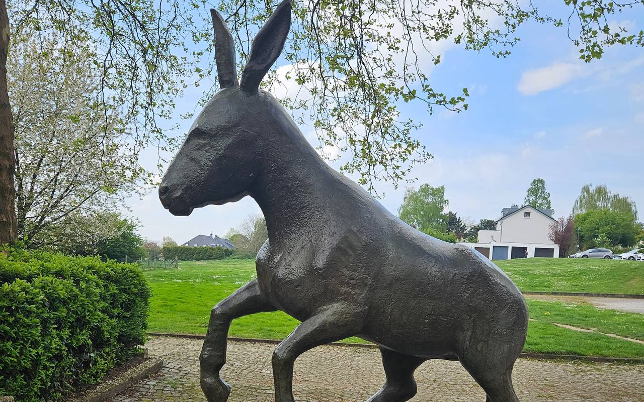 Statue "Springender Esel" mit Wiese im Hintergrund