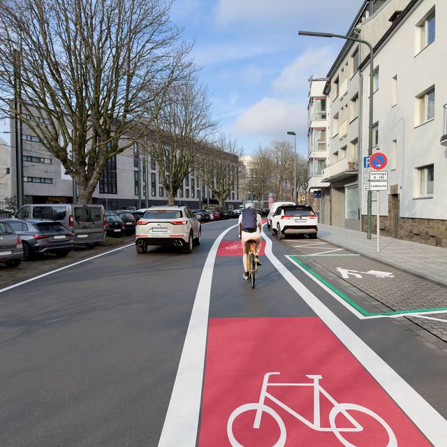 Animation, auf der zu sehen ist, wie ein Radfahrer in Zukunft über die neue Rad-Leitroute fahren wird. Im Bild zu sehen ist der Radweg auf der Hansaallee neben parkenden und fahrenden Autos.