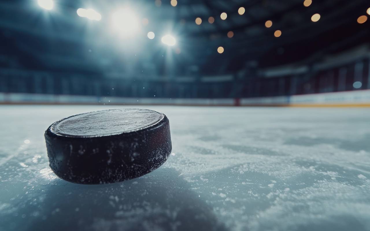 Ein Eishockey-Puck fliegt über das Eis.
