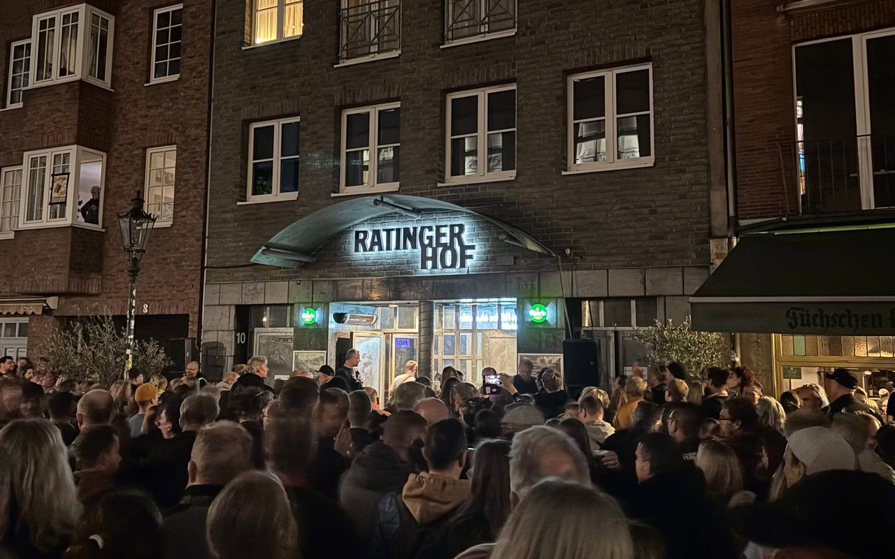 Fans der Toten Hosen verfolgen auf der Ratinger Straße per Lautsprecher ein Konzert der Toten Hosen im Ratinger Hof.