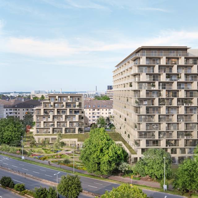 Eine Visualisierung eines Wohnquartiers am Kennedydamm. Mehrere Wohnhäuser stehen am Kennedydamm. Rundherum gibt es einige Grünflächen.