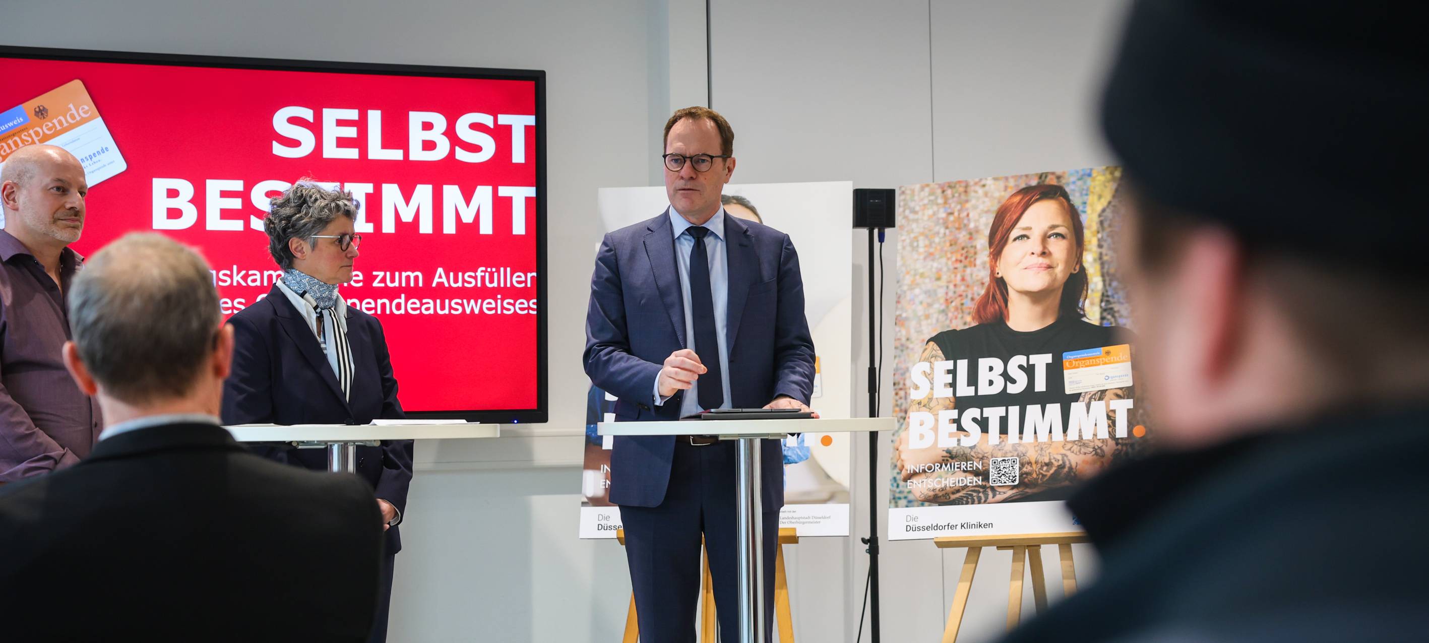 Oberbürgermeister Stephan Keller spricht auf einer Bühne zum Thema Organspende