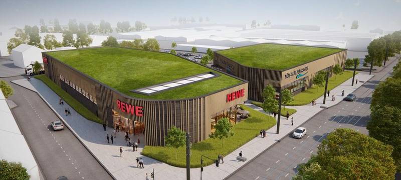 So sollen der neue REWE und das neue Hallenbad an der Ulmenstraße einmal aussehen. Für das Bad rechnet Bezirksbürgermeisterin Schentek mit einer Eröffnung frühestens Ende 2028.