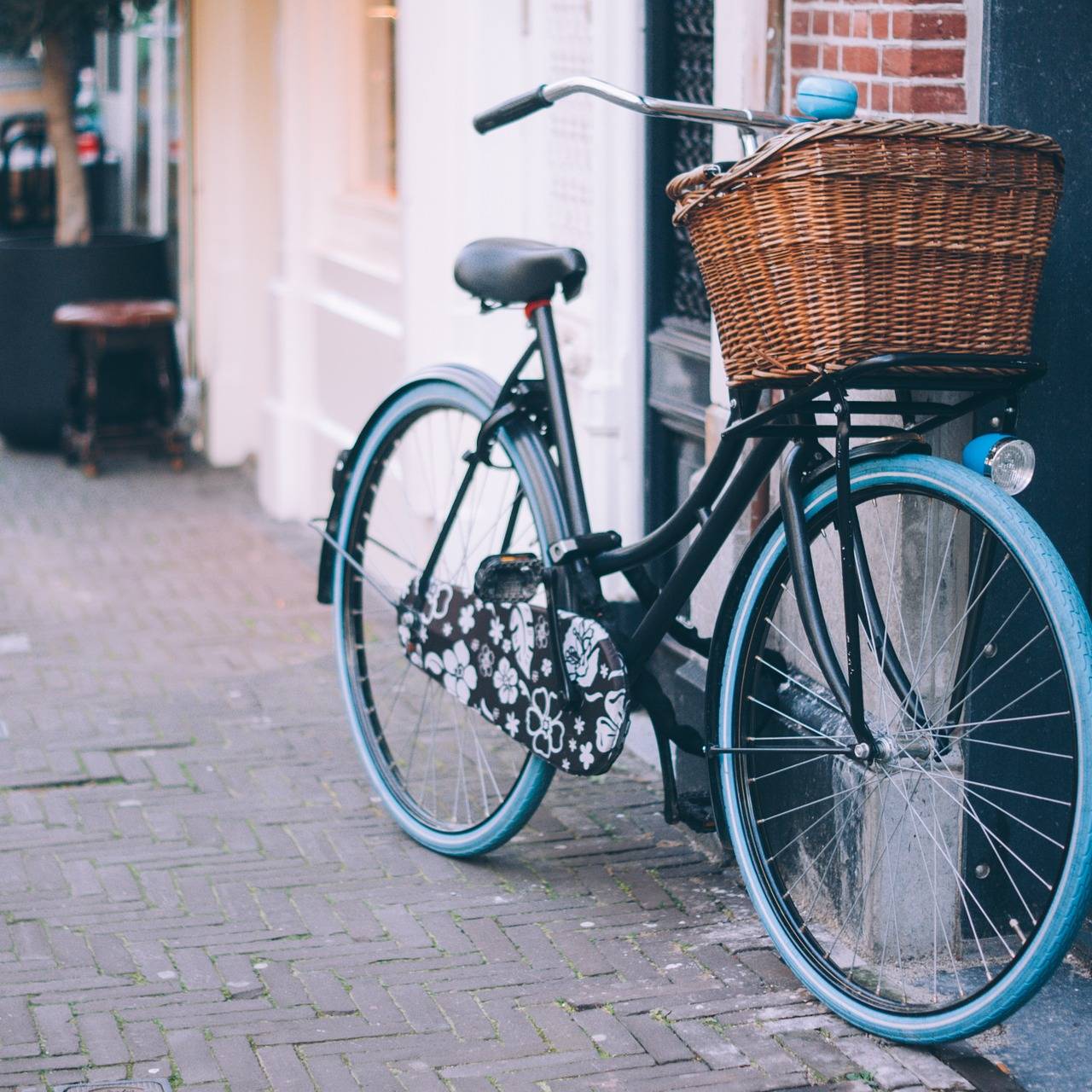 Ein Fahrrad mit blauen Reifen und einem braunen Körbchen.