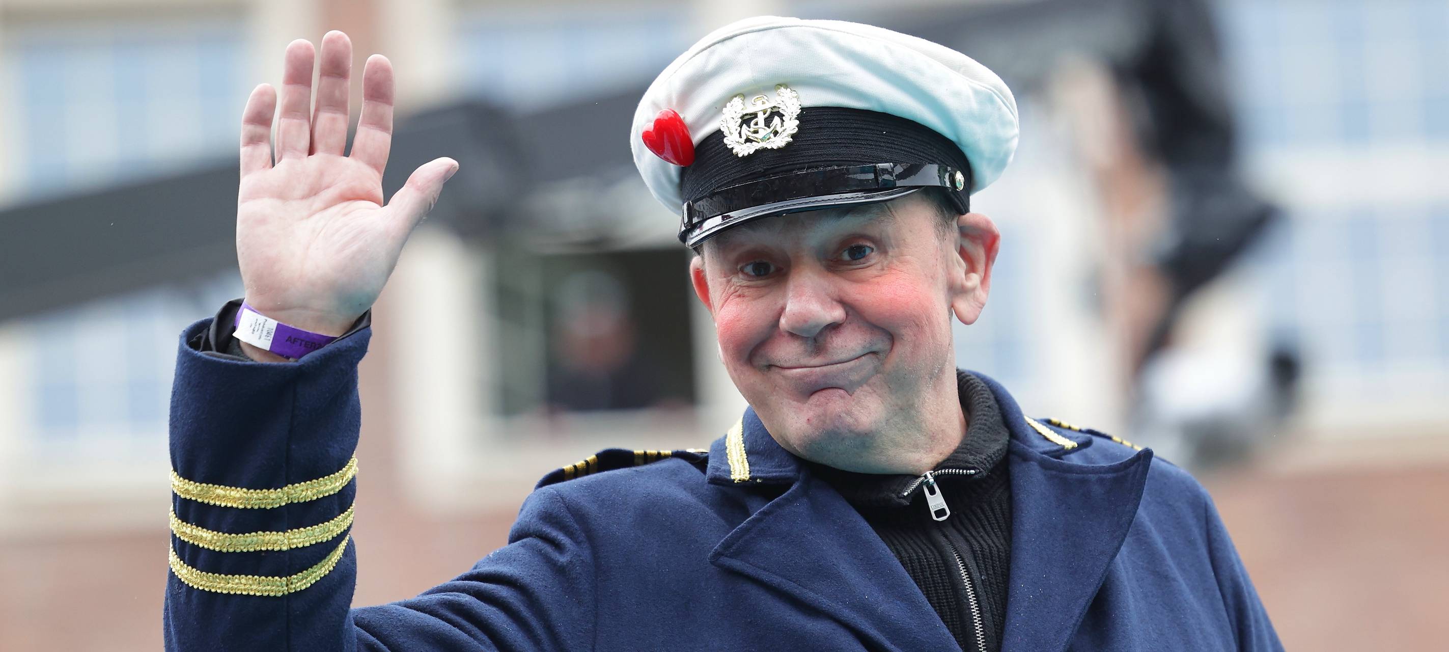 Jacques Tilly grüßt als Captain mit weißer Mütze beim Rosenmontagszug 2026.